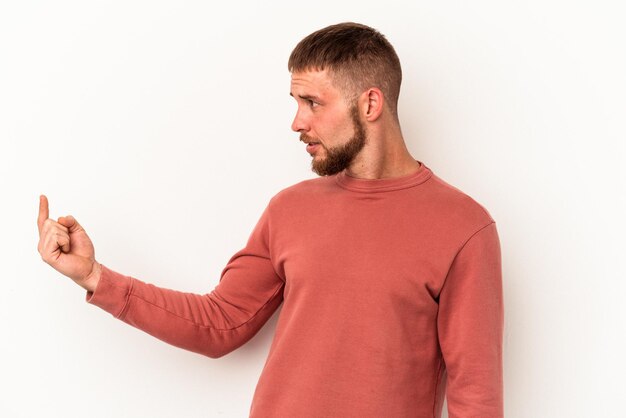 Junger kaukasischer Mann mit Diastema isoliert auf weißem Hintergrund, der mit dem Finger auf Sie zeigt, als ob er einladen würde, näher zu kommen.