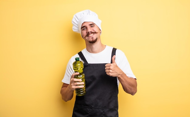 Junger Koch mit Schnurrbart mit Olivenölflasche