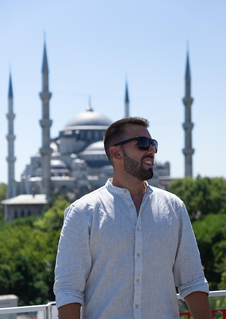 Junger männlicher Tourist zufrieden mit Sonnenbrille und hinter der blauen Moschee in Istanbul