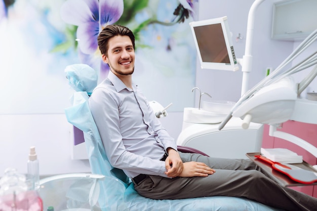 Junger Mann am Zahnarztstuhl während eines zahnärztlichen Eingriffs Überblick über die Vorbeugung von Zahnkaries