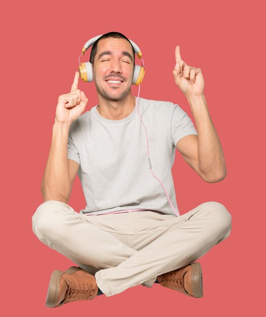 Junger Mann in sitzender Position mit einer Feiergeste