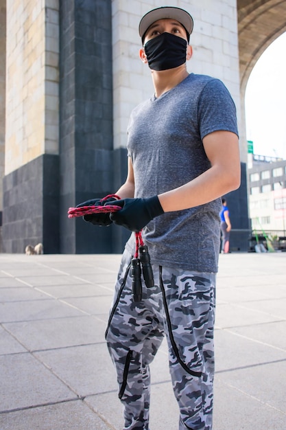 Junger Mann mit einem Springseil in einem Park