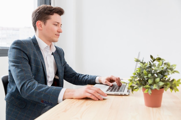 Foto junger profi, der am laptop arbeitet