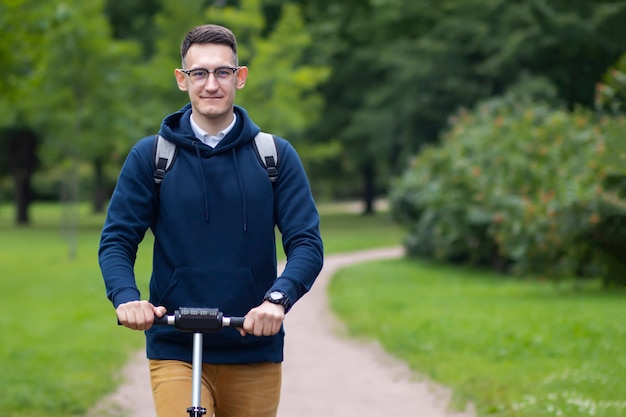 junger Student fährt auf Elektroroller