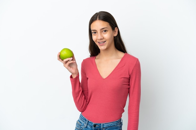 Junges französisches Mädchen isoliert auf weißem Hintergrund mit einem Apfel