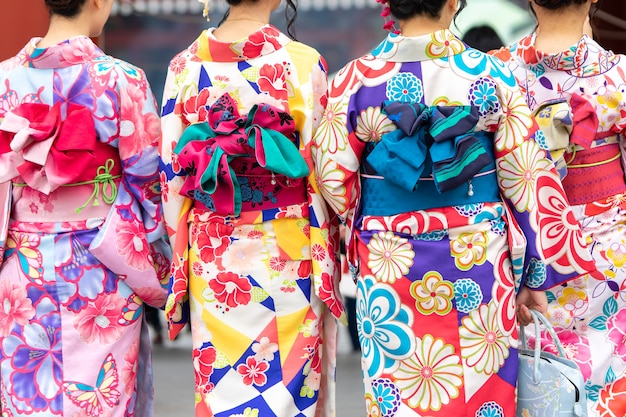 Foto junges mädchen, das den japanischen kimono steht vor sensoji-tempel in tokyo trägt