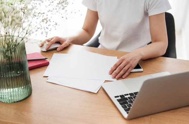 Junges Mädchen, das im Homeoffice am Tisch arbeitet