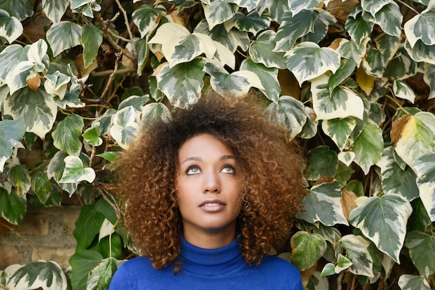 Junges Mädchen mit Afrofrisur im städtischen Hintergrund