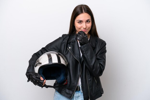 Junges Mädchen mit einem Motorradhelm isoliert auf weißem Hintergrund mit Zweifeln und Denken