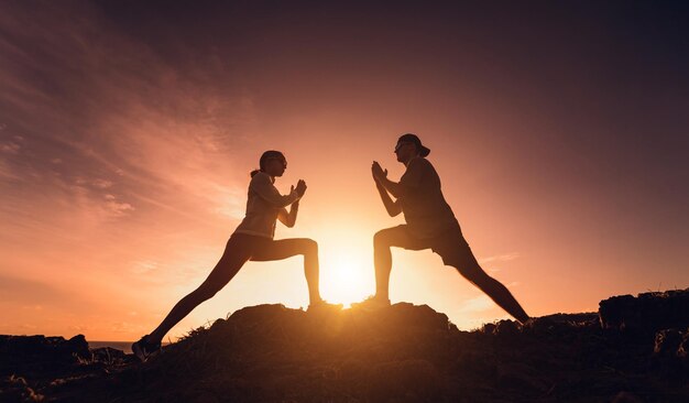 Junges Paar macht Yoga-Übungen am Bergrand bei Sonnenaufgang