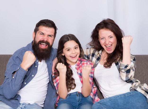 Juntos somos ganadores. Los ganadores celebran la victoria en casa. La familia feliz hace gestos de victoria. Familia de ganadores. celebración de vacaciones. Campeones y vencedores. Los ganadores nunca se dan por vencidos.