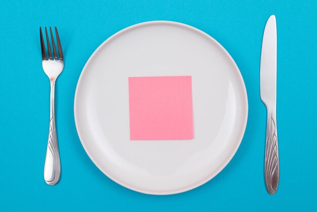 Foto justo por encima de la toma de un plato vacío en la mesa contra un fondo azul