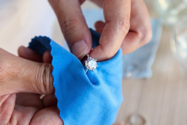 Foto juwelier handpolieren und reinigen von schmuck diamantring mit mikrofasergewebe