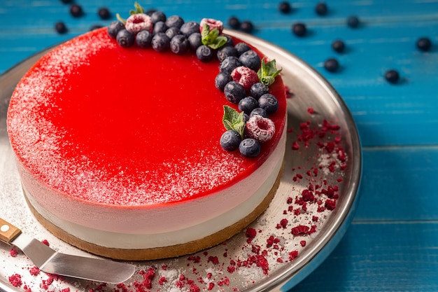 Käsekuchen auf Mürbeteig mit Frischkäseauflauf und Beerenpüree, garniert mit frischen Heidelbeeren, Himbeeren und Minze