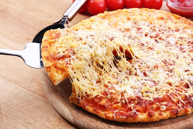 Foto käsepizza auf hölzerner schneidebrettnahaufnahme