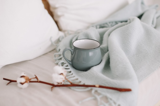 Kaffeetasse und Baumwollzweig Frühstück im Bett