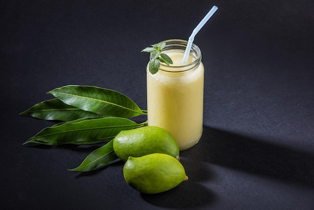 Kairi panha ou panna ou raw mango drink é uma bebida tradicional e popular no verão indiano servida em um copo sobre um fundo colorido ou de madeira. foco seletivo