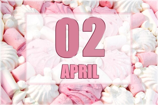 Kalenderdatum auf dem Hintergrund von weißen und rosa Marshmallows 2. April ist der zweite Tag des Monats