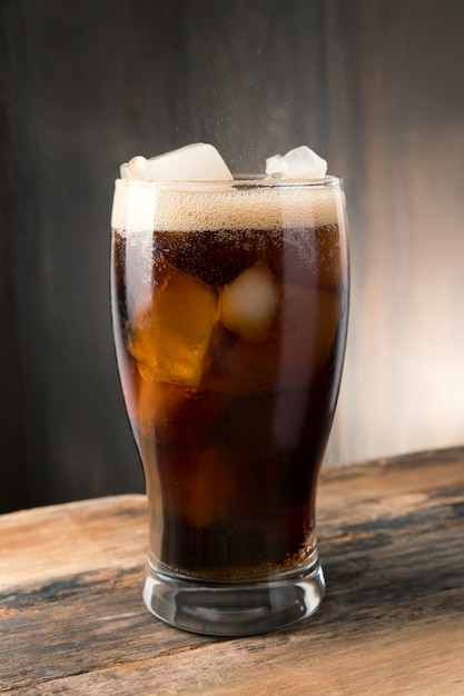 Kaltes sprudelndes Cola Soda mit Eis in der Glasschale