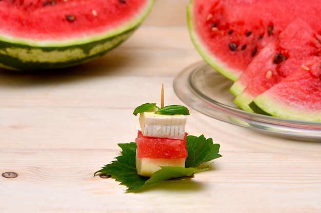 Foto kanapees mit scheiben wassermelonenkäse und pfirsich