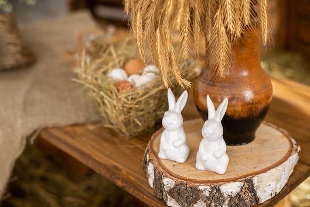 Kaninchenfiguren Ostern Dekor auf einem hölzernen Hintergrund