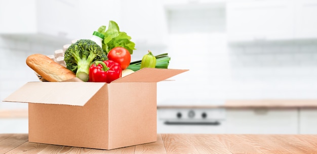 Karton mit Essen auf dem Küchentisch, Lieferung nach Hause