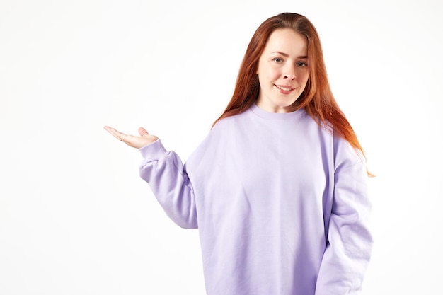 Kaukasische Frau im violetten Sweatshirt Natürliches Aussehen Lächelndes langes rotes Haar Weißer Hintergrund