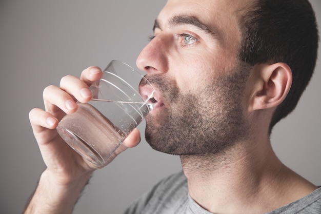 Kaukasischer Mann, der frisches Wasser trinkt.