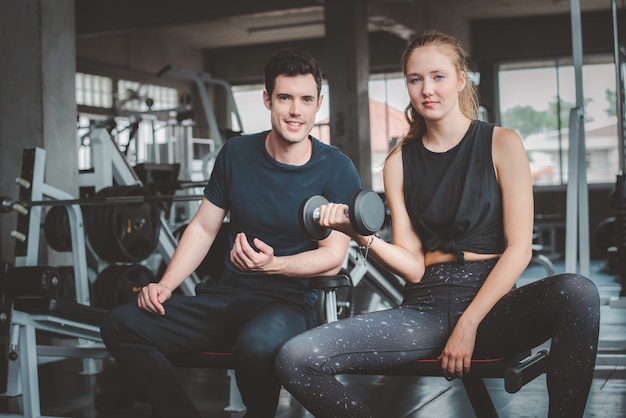 Kaukasisches Paar auf der Bank im Fitness-Studio