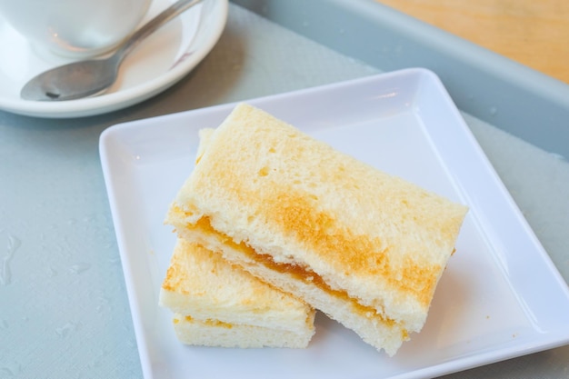 Kaya tostadas con una taza de té en la mesa