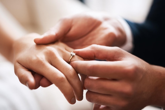 Kein Diamant kann sich mit dieser kostbaren Liebe vergleichen. Schnappschuss eines unerkennbaren Bräutigams, der seiner Frau während ihrer Hochzeit einen Diamantring an den Finger steckt