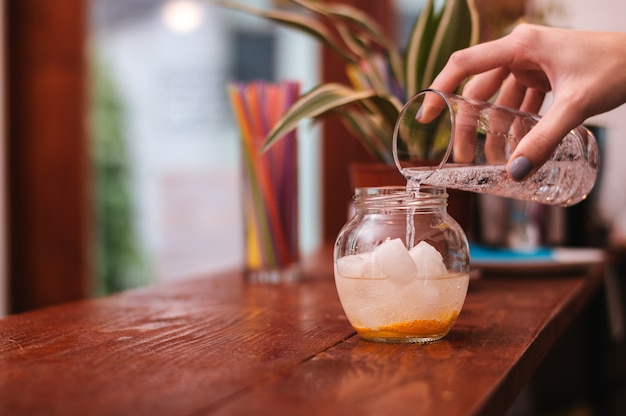 Foto kellner, der cocktail am café macht