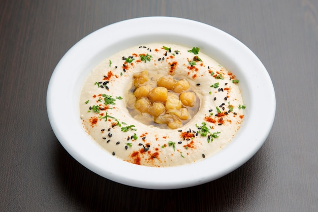 Kichererbsencreme Hummus, typisch arabisches Essen auf Holz