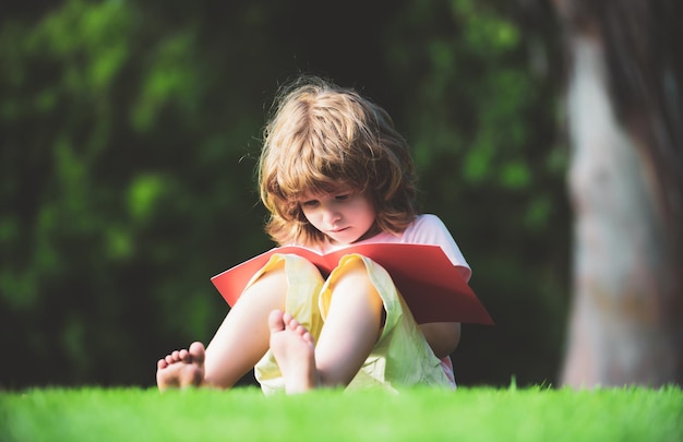 Kind, das schreiben lernt, Vorschulerziehung. Kindererziehung im Freien. Fernunterricht für Kinder mit Bleistift, um das Schreiben auf einem Buch zu üben.