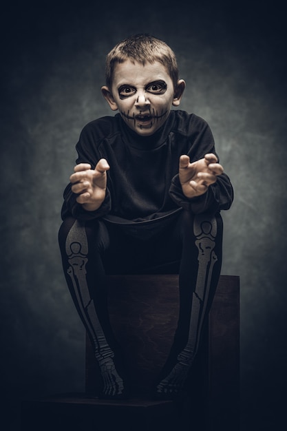 Kind gekleidet und als Skelett für Halloween-Party geschminkt
