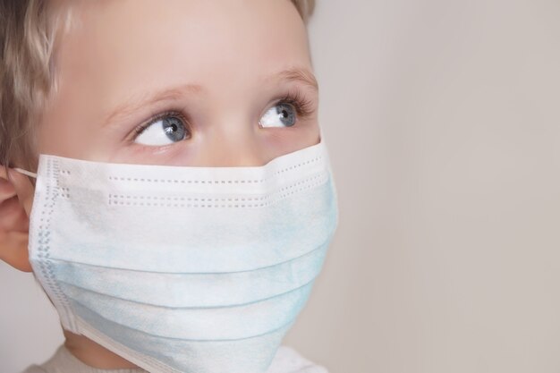 Kind in blauer medizinischer MaskeNahaufnahmefotografieGesundheit vor verschiedenen Viren schützen