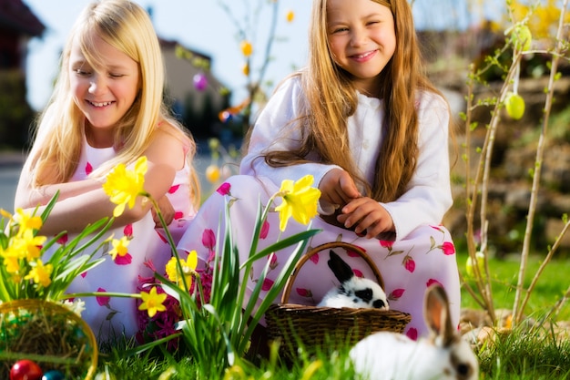 Kinder auf Ostereiersuche mit Hase