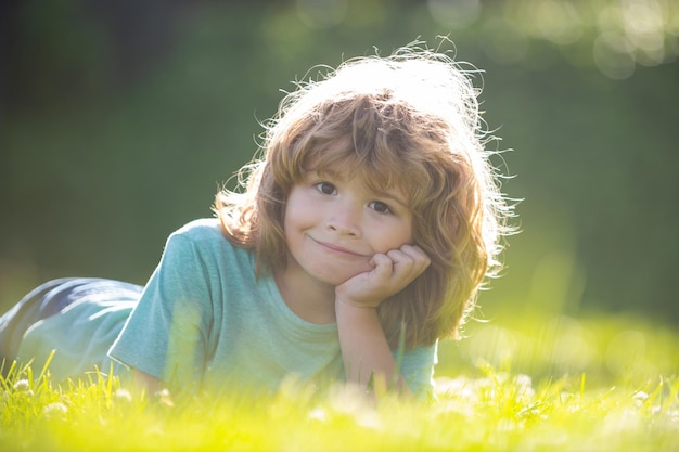 Kinder, die auf Gras legen süßes Kind im Sommernatur-Rasenpark