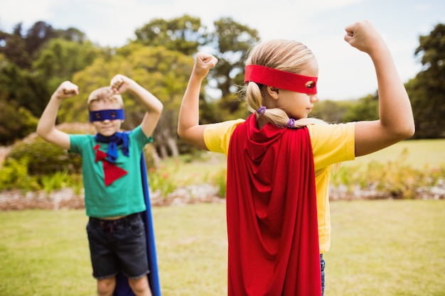 Kinder, welche die Superheldkostümaufstellung tragen