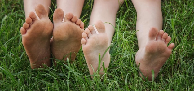 Foto kinderbeine auf grünem gras. selektiver fokus kind