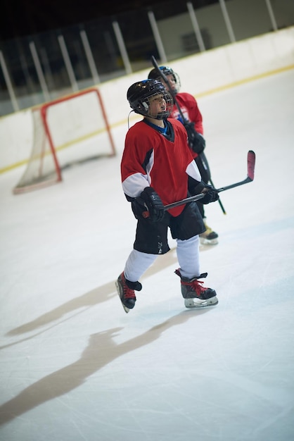 kindereishockeyspieler, gruppen von personen, teamfreunde, die auf der bank warten und sich entspannen, um das spiel zu starten