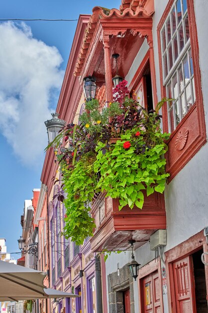 Klassisches Gebäude mit Blumen und Pflanzen auf dem Balkon in der Stadt Santa Cruz de La Palma Alte Häuser in traditioneller Architektur mit Terrassengarten in einer Stadt oder einem Dorf im Sommer