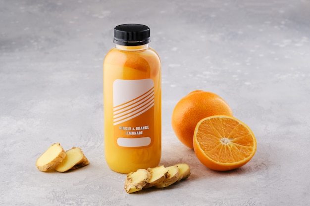 Kleine Flasche mit Orangen-Ingwer-Limonade auf dem Tisch