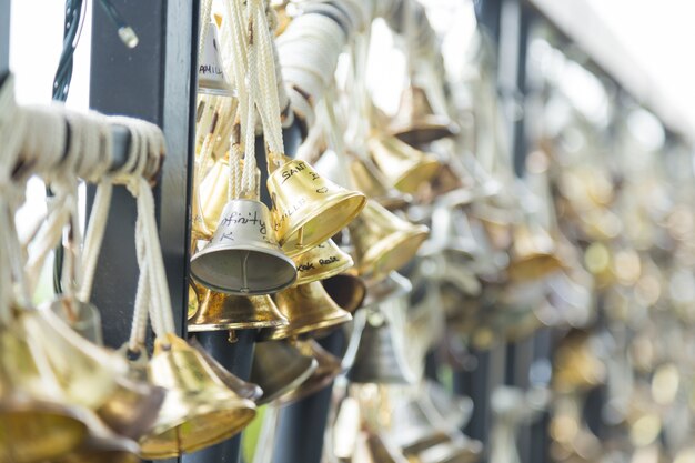 Kleine Glocke an einen Zaun gebunden.