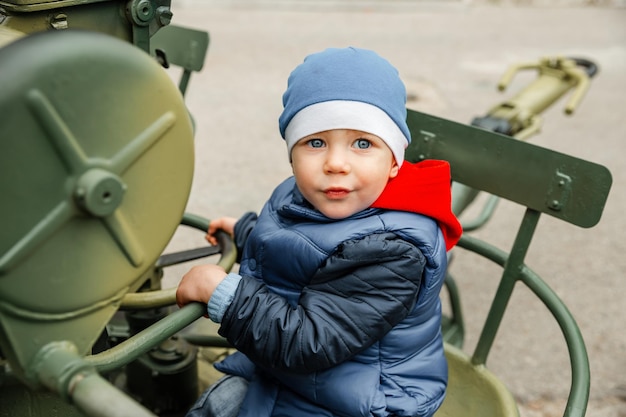 Foto kleine jungen spielen mit einem historischen panzer aus dem ersten weltkrieg porträt eines jungen