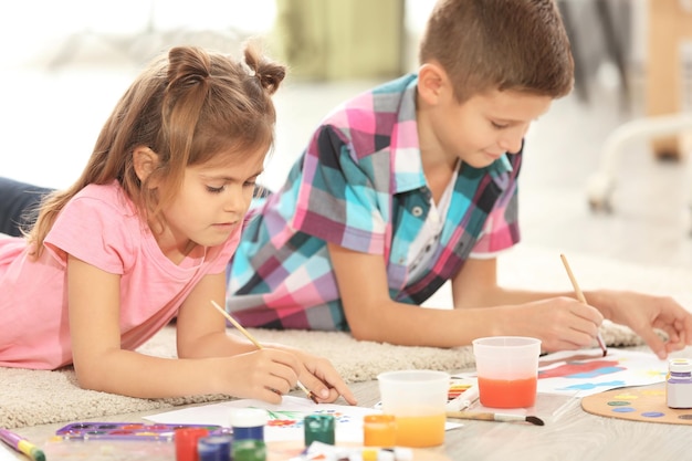 Kleine Kinder malen auf dem Boden