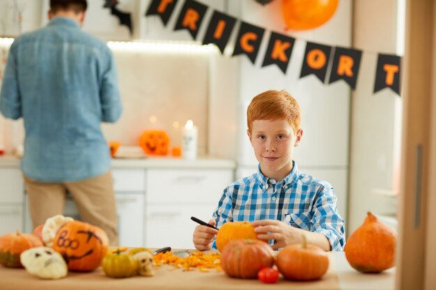 Kleiner Junge, der Jack O 'Lantern macht