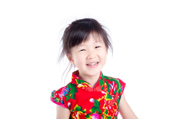 Kleines chinesisches Mädchen, das über weißem Hintergrund lächelt