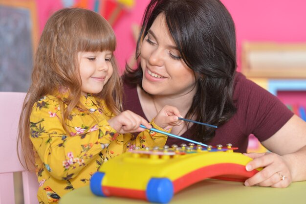 Kleines Mädchen, das mit Mutter spielt