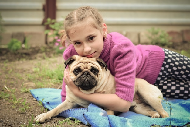 Kleines Mädchen mit ihrem Hund draußen